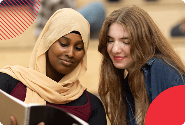 Two students looking a a book