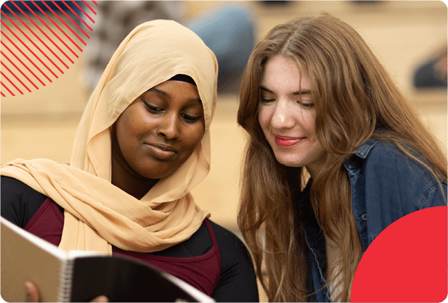 Two students looking at a book